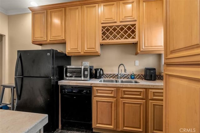 kitchen featuring light countertops, ornamental molding, a toaster, a sink, and black appliances