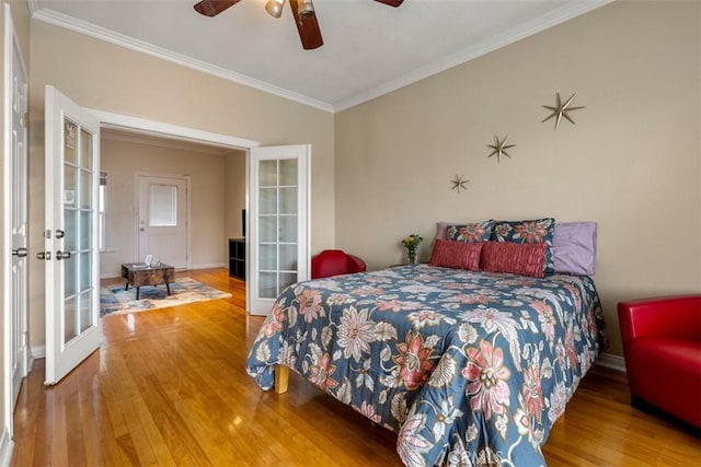 bedroom featuring french doors, hardwood / wood-style floors, ornamental molding, and ceiling fan