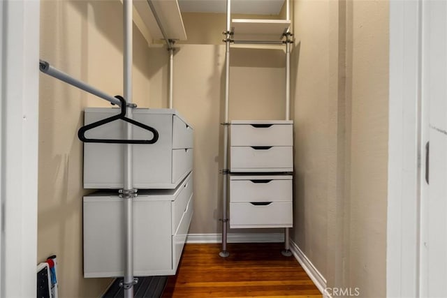 interior space with baseboards and wood finished floors