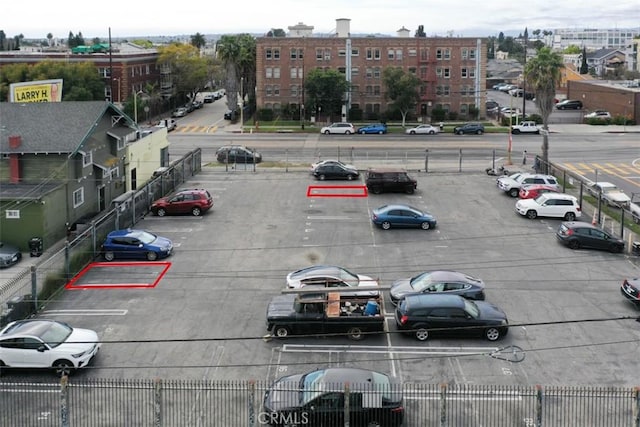 view of vehicle parking with fence