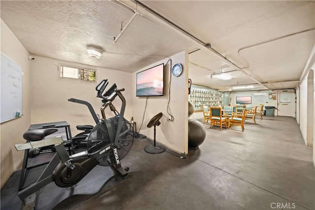 exercise area featuring a textured ceiling