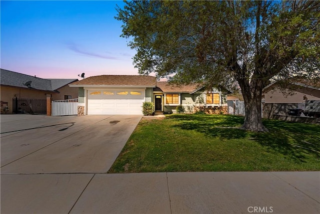 38115 41st St E, Palmdale, CA 93552 - ranch-style house featuring concrete driveway, stucco siding, fence, a lawn, and a garage