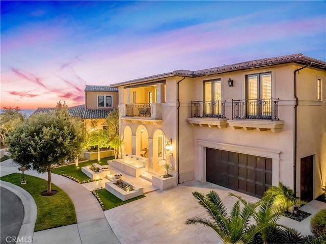 31 Seawatch, Newport Coast, CA 92657 - mediterranean / spanish-style house with a balcony, french doors, stucco siding, and concrete driveway