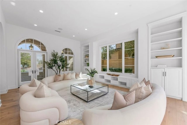 31 Seawatch, Newport Coast, CA 92657 - living room featuring french doors, built in features, recessed lighting, and light wood-type flooring