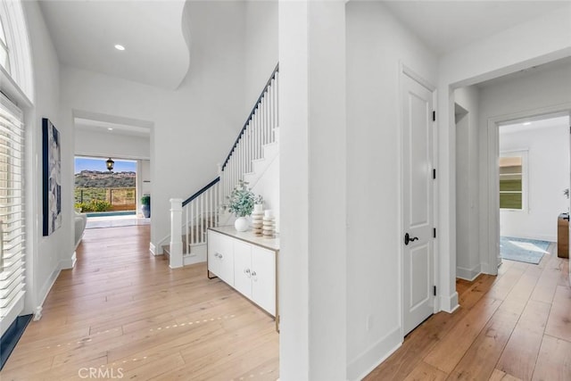 31 Seawatch, Newport Coast, CA 92657 - hall featuring stairway, light wood-style floors, baseboards, and recessed lighting