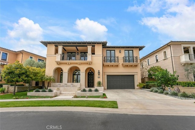 31 Seawatch, Newport Coast, CA 92657 - mediterranean / spanish house with a balcony, stucco siding, concrete driveway, and an attached garage