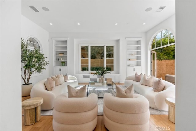 31 Seawatch, Newport Coast, CA 92657 - living area with built in shelves, light wood-style floors, and recessed lighting