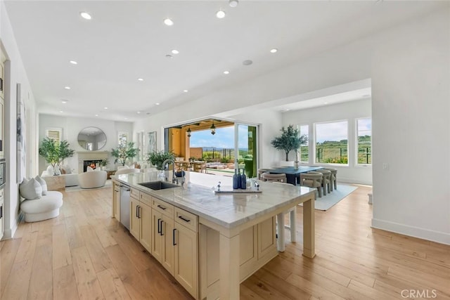 31 Seawatch, Newport Coast, CA 92657 - kitchen featuring open floor plan, a sink, stainless steel dishwasher, a large island with sink, and light wood-style floors