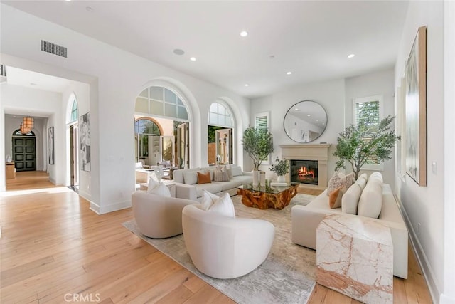 31 Seawatch, Newport Coast, CA 92657 - living room featuring light wood-type flooring, recessed lighting, a glass covered fireplace, and baseboards