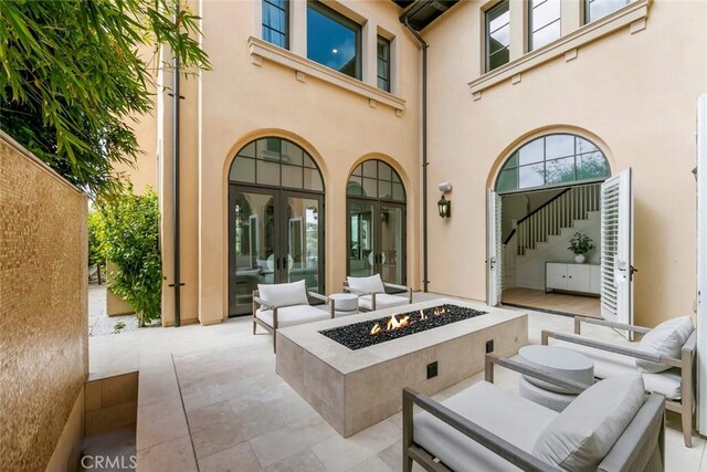 31 Seawatch, Newport Coast, CA 92657 - view of patio with french doors and an outdoor living space with a fire pit