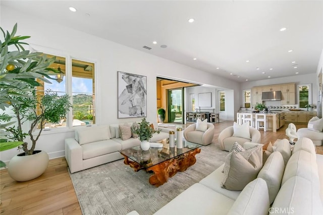 31 Seawatch, Newport Coast, CA 92657 - living room featuring recessed lighting, light wood-style flooring, and baseboards