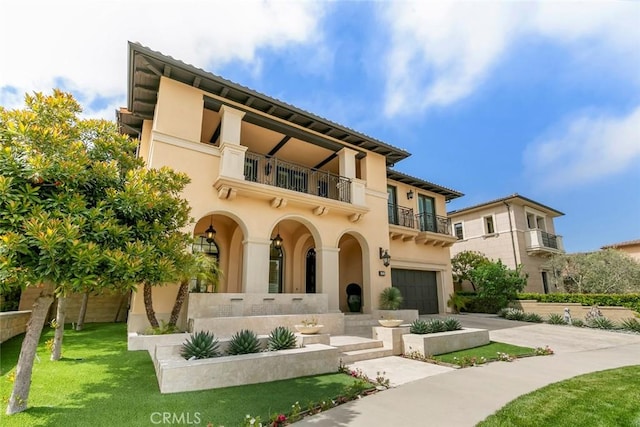 31 Seawatch, Newport Coast, CA 92657 - back of property with a balcony, an attached garage, driveway, and stucco siding