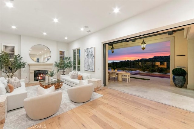 31 Seawatch, Newport Coast, CA 92657 - living area featuring hardwood / wood-style flooring, recessed lighting, and a warm lit fireplace