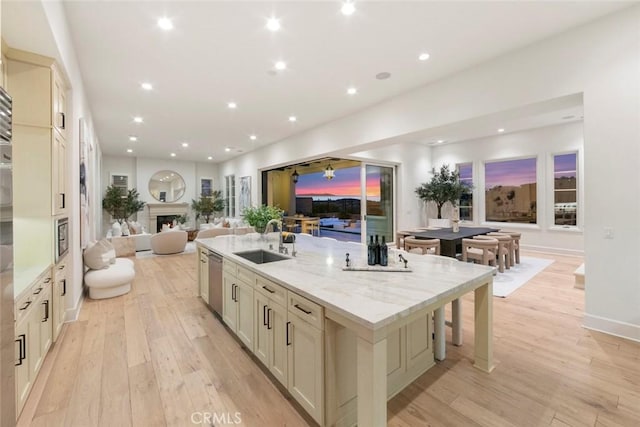 31 Seawatch, Newport Coast, CA 92657 - kitchen featuring a sink, open floor plan, a spacious island, dishwasher, and light wood finished floors