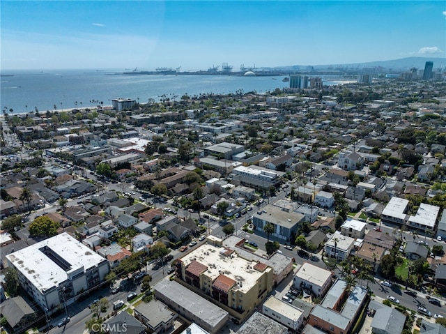 drone / aerial view featuring a water view and a view of city