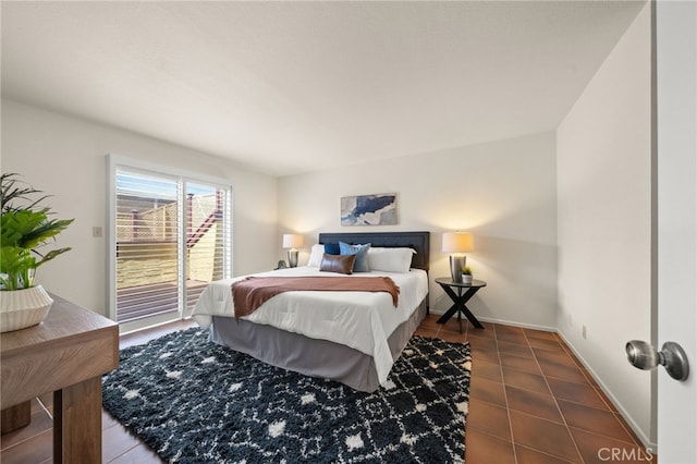 bedroom with tile patterned floors, baseboards, and access to outside