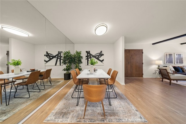 dining room with baseboards and wood finished floors