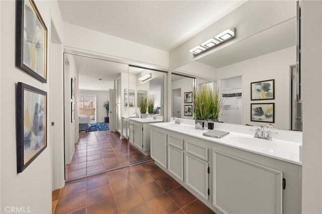 bathroom featuring double vanity, a sink, and tile patterned flooring
