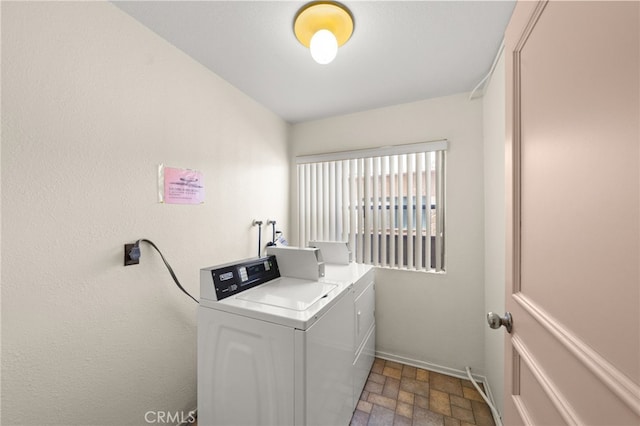 laundry area with independent washer and dryer, baseboards, and laundry area