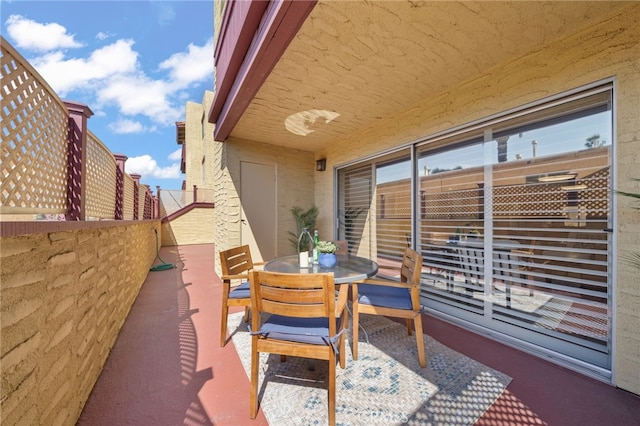 view of patio / terrace with a balcony and outdoor dining space