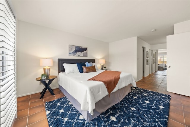 tiled bedroom featuring baseboards