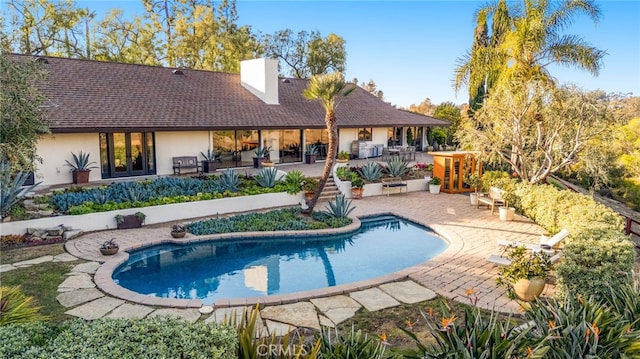 outdoor pool featuring a patio