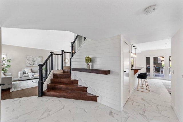 stairway with baseboards and marble finish floor