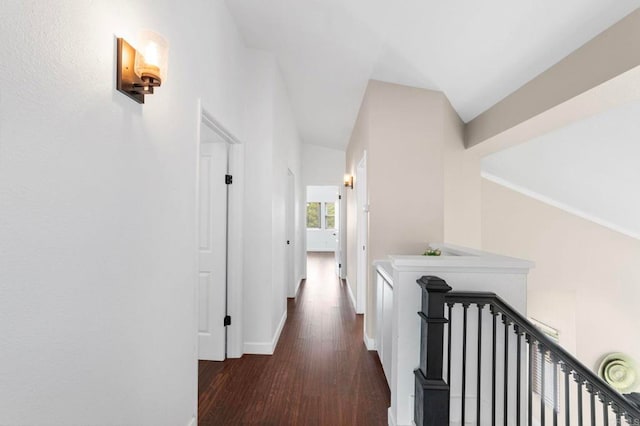 hall featuring baseboards and wood finished floors