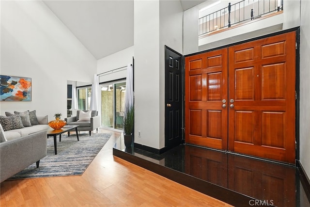 5447 E Centralia St, Long Beach, CA 90808 - foyer entrance with high vaulted ceiling, wood finished floors, and baseboards