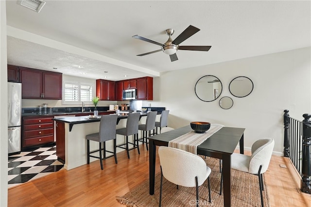 5447 E Centralia St, Long Beach, CA 90808 - dining area featuring a ceiling fan and light wood-style floors