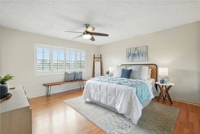 5447 E Centralia St, Long Beach, CA 90808 - bedroom with wood finished floors, a textured ceiling, a ceiling fan, and baseboards