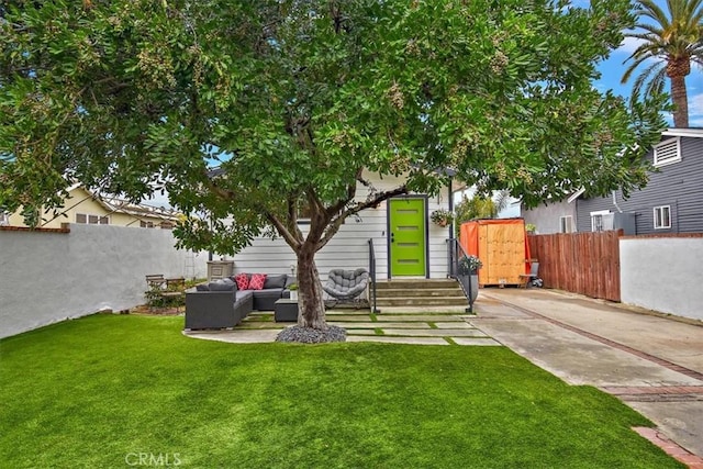 exterior space featuring a patio, a fenced backyard, outdoor lounge area, and entry steps