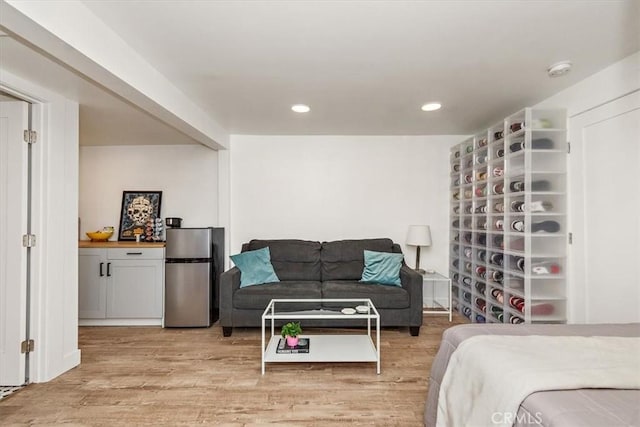 bedroom featuring freestanding refrigerator, recessed lighting, and light wood-style flooring