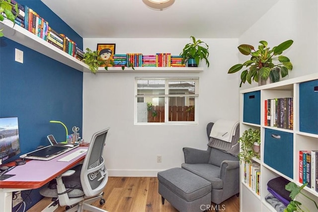 home office featuring baseboards and wood finished floors