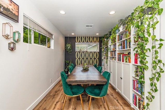 dining room featuring baseboards, recessed lighting, wood finished floors, and visible vents