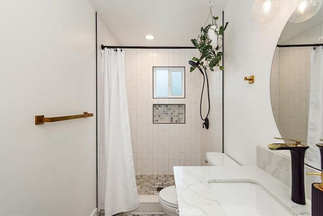 full bathroom with toilet, recessed lighting, tiled shower, and vanity