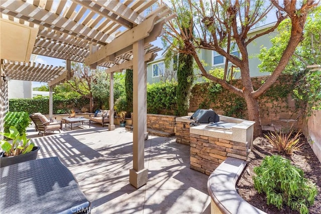 view of patio / terrace featuring a pergola, an outdoor living space, a fenced backyard, exterior kitchen, and area for grilling