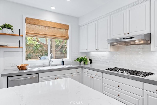kitchen featuring a sink, stainless steel appliances, white cabinetry, under cabinet range hood, and recessed lighting