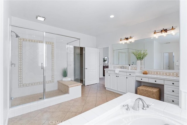 full bath with tile patterned flooring, visible vents, vanity, a garden tub, and a stall shower