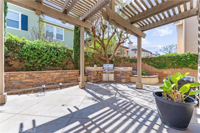 view of patio with exterior kitchen, a pergola, area for grilling, and fence