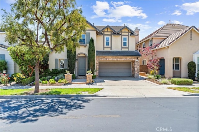 view of front of property with stucco siding, driveway, and a garage