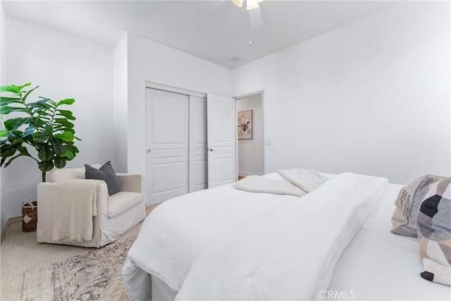 bedroom featuring baseboards, a closet, and ceiling fan
