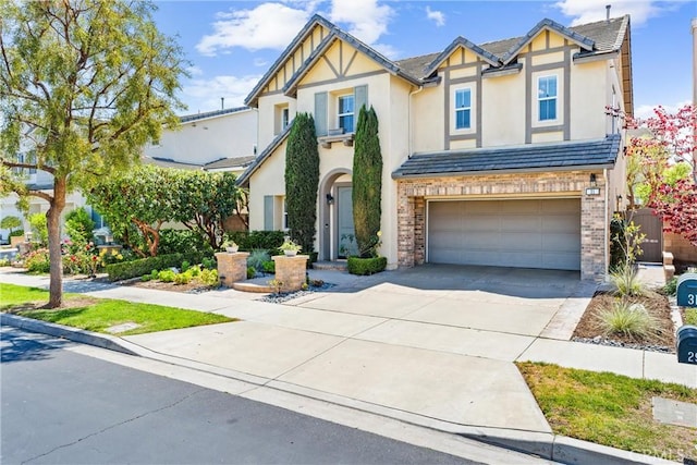 view of front facade featuring stucco siding, driveway, and a garage