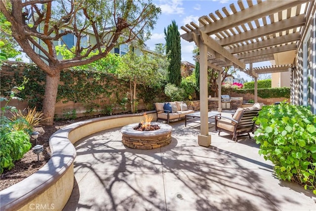 view of patio / terrace with a pergola, an outdoor living space with a fire pit, and a fenced backyard