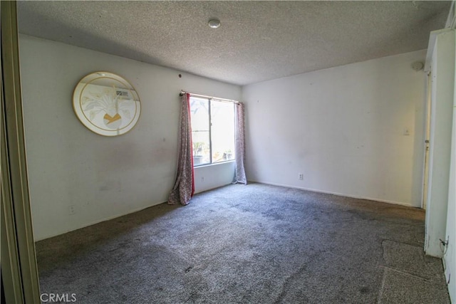 carpeted spare room featuring a textured ceiling