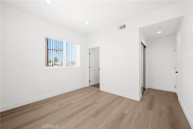 unfurnished bedroom featuring recessed lighting, baseboards, visible vents, and light wood-type flooring