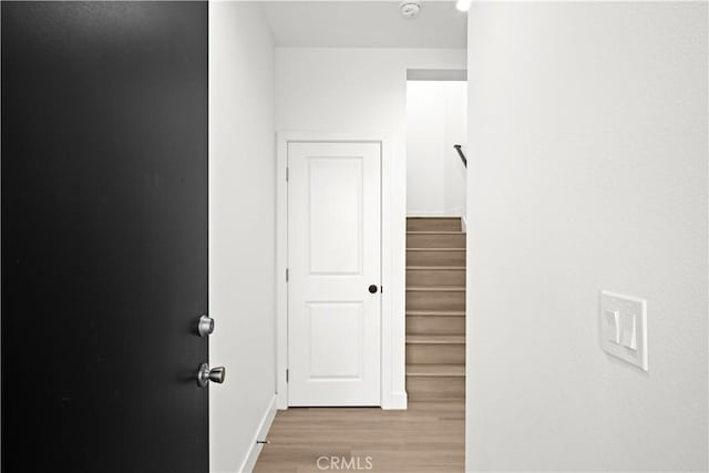 corridor with light wood-type flooring