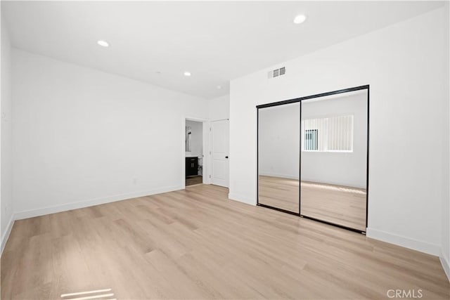 unfurnished bedroom featuring light wood-style flooring, recessed lighting, and visible vents