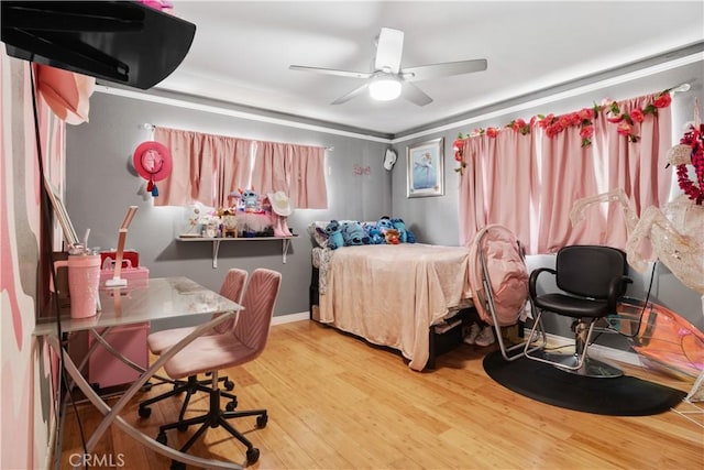 bedroom featuring a ceiling fan and wood finished floors