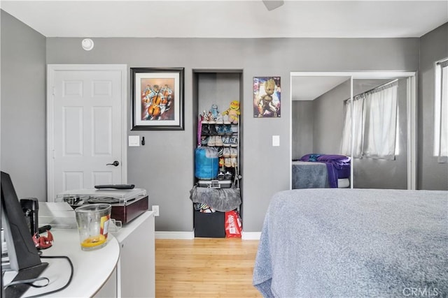 bedroom with light wood-type flooring and baseboards